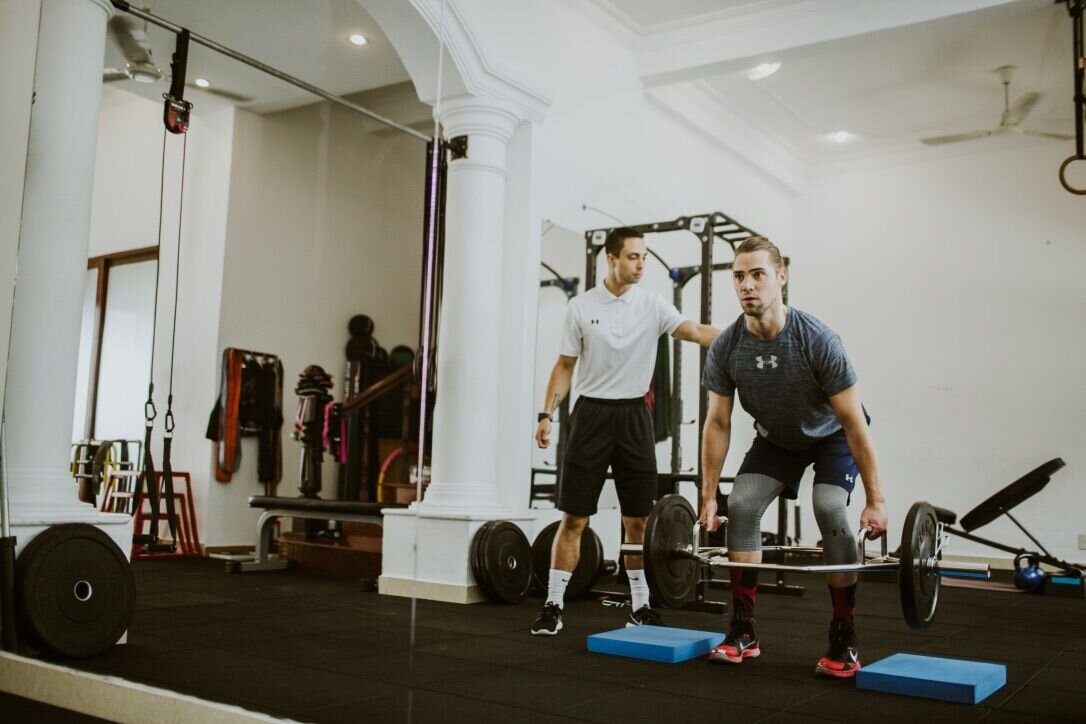 Justin Parkes coaching a client on the gym floor